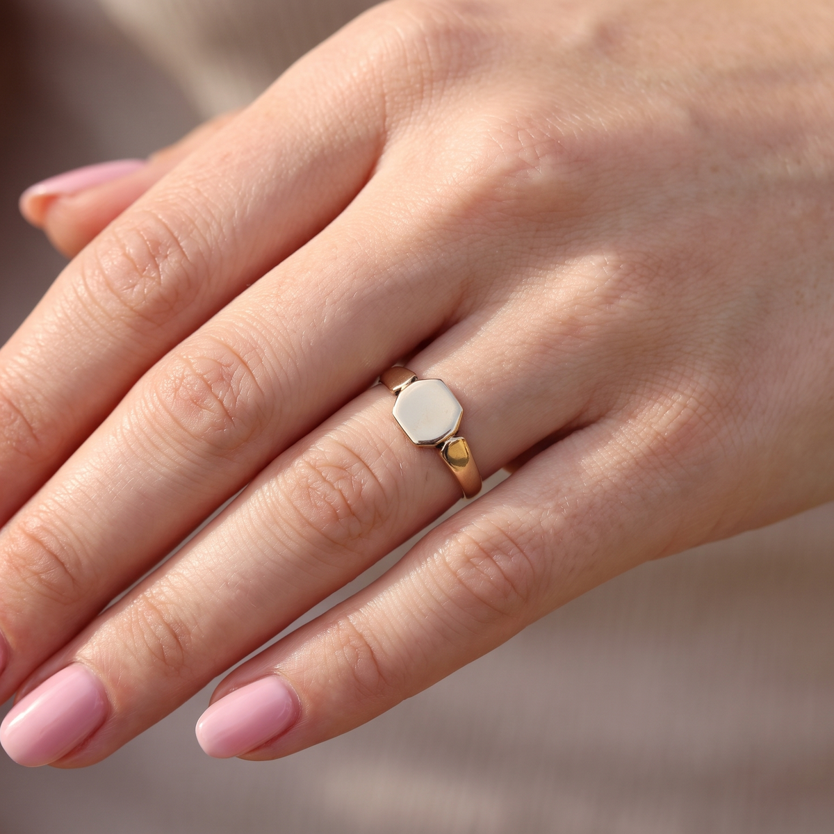 hand A vintage 9 carat gold signet ring. Six sided head shape,