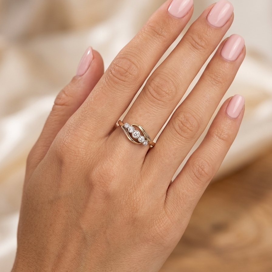 hand A vintage cross over style ring. Set with five old brilliant cut white diamonds. Centre stone 3mm, each side 2.4mm, each end 1.5mm. Total diamond content estimated at 0.22 carats.
