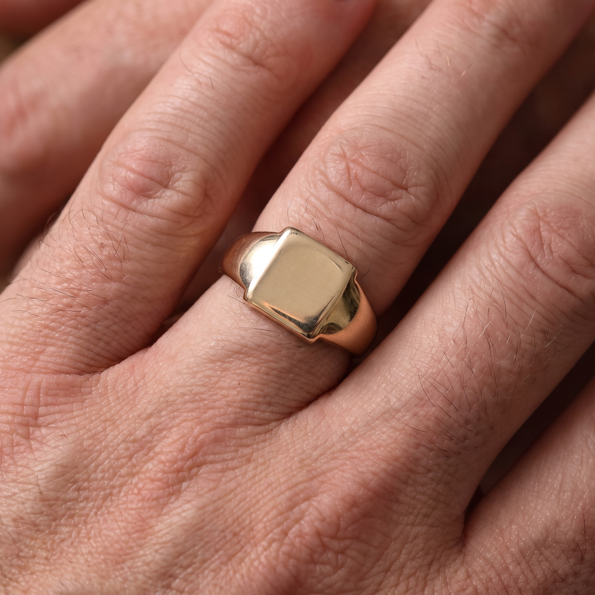 hand A vintage gentleman's 9 carat gold signet ring. Polished square head, measures 11x11mm, weight 5 grams. 