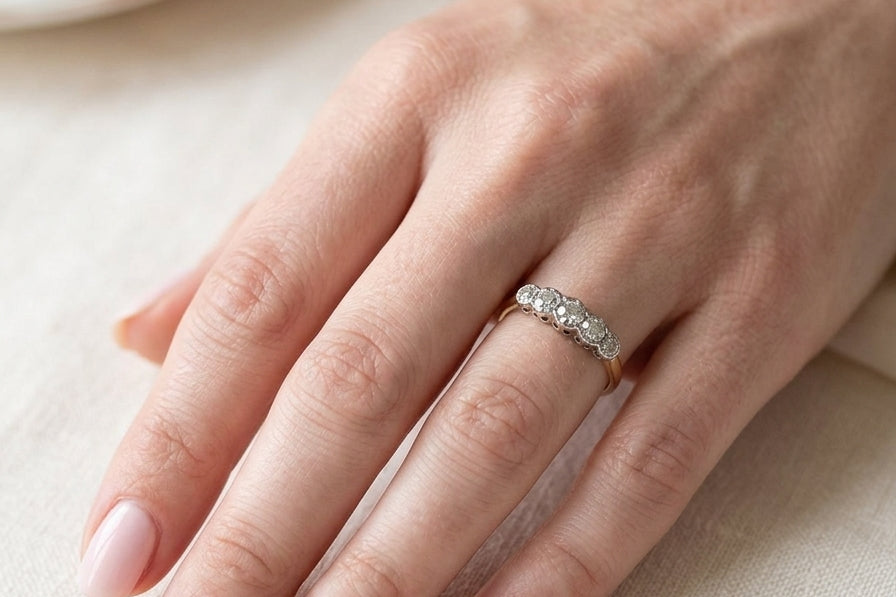 hand A vintage ring containing five old brilliant cut white diamonds. Centre 3mm, each side 2.2mm, at each end a 1.8mm diamond. Total diamond content estimated at 0.25 carats. All illusion set in platinum