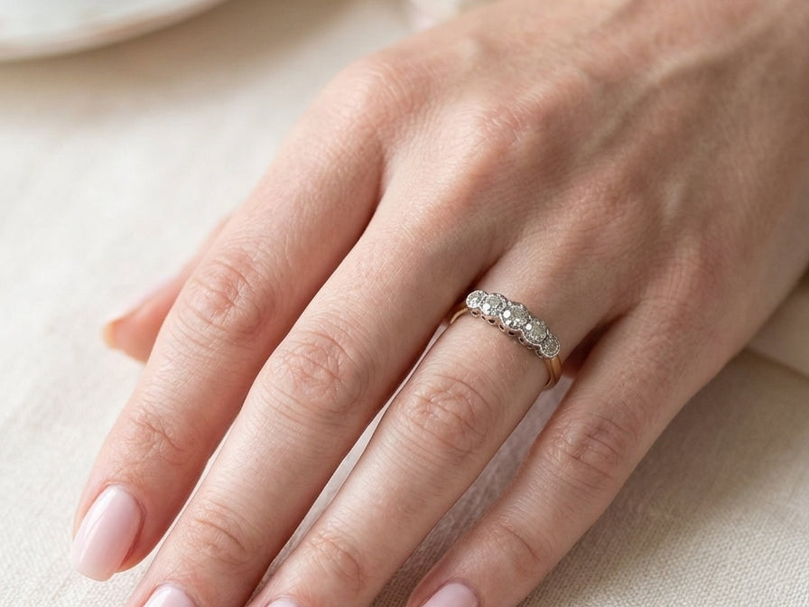 hand A vintage ring containing five old brilliant cut white diamonds. Centre 3mm, each side 2.2mm, at each end a 1.8mm diamond. Total diamond content estimated at 0.25 carats. All illusion set in platinum