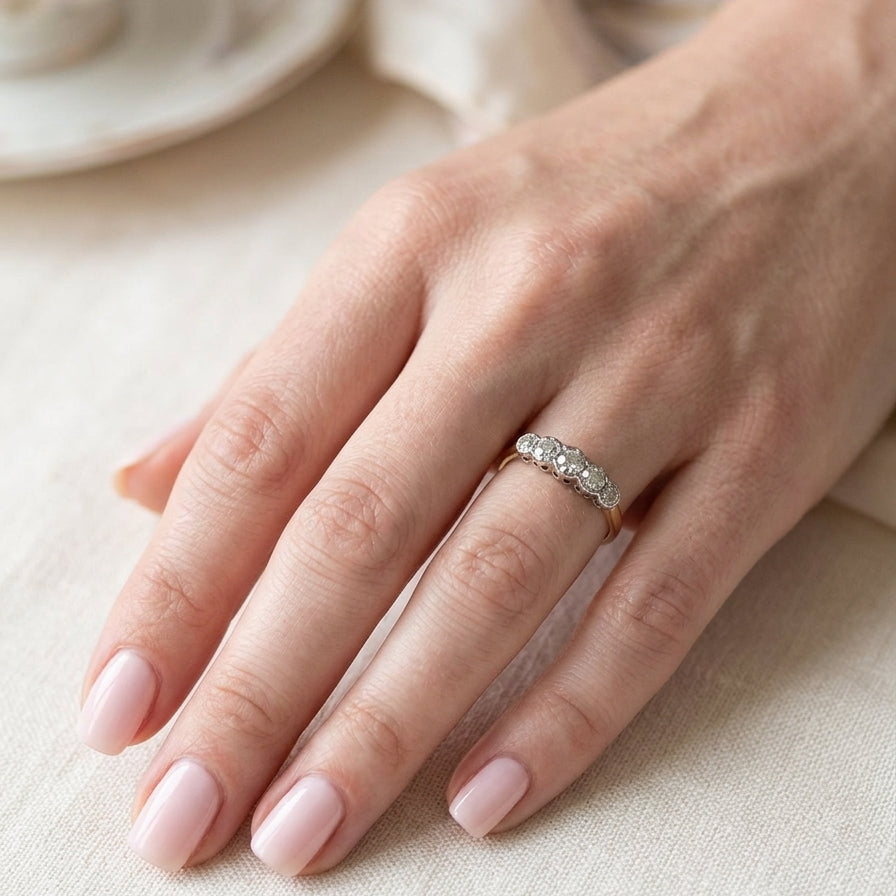 hand A vintage ring containing five old brilliant cut white diamonds. Centre 3mm, each side 2.2mm, at each end a 1.8mm diamond. Total diamond content estimated at 0.25 carats. All illusion set in platinum