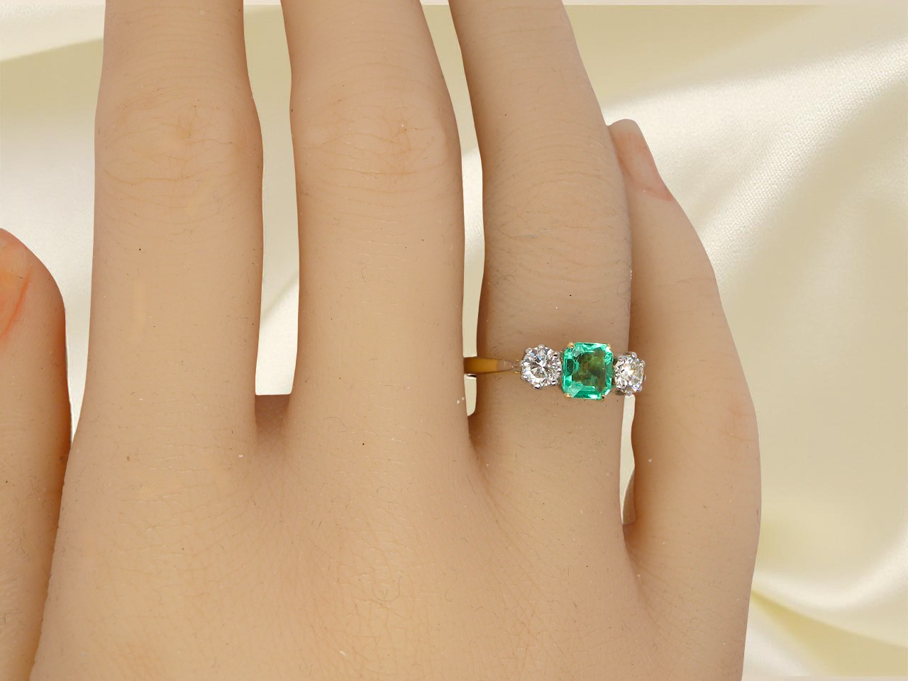 A vintage three stone Emerald and Diamond ring