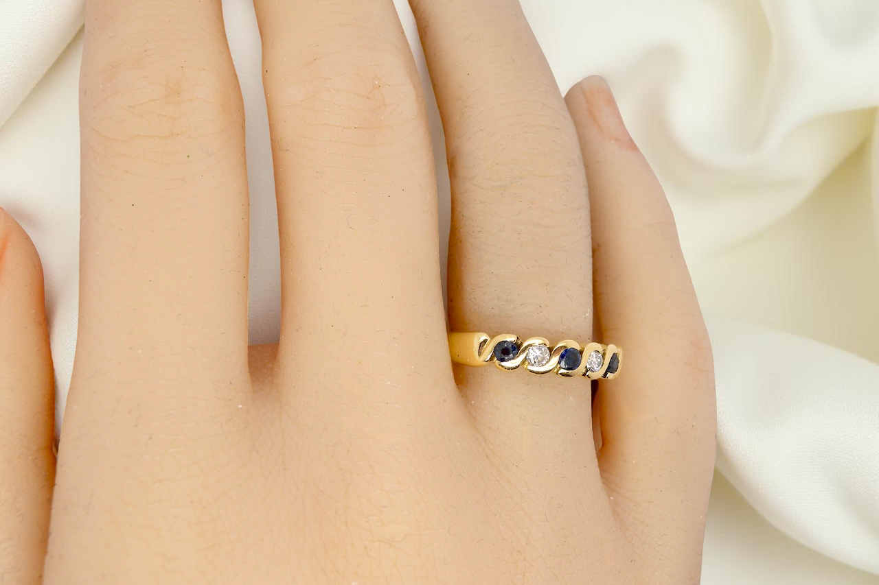 An 18 carat gold Sapphire and Diamond eternity ring