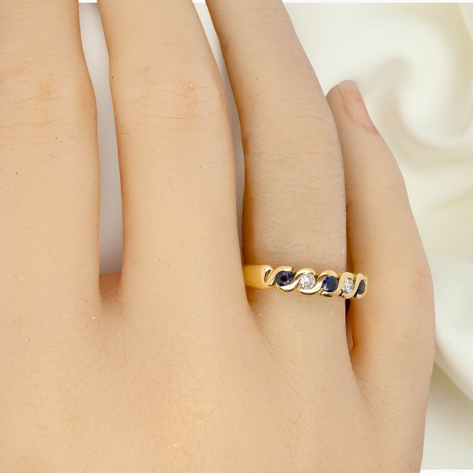 An 18 carat gold Sapphire and Diamond eternity ring