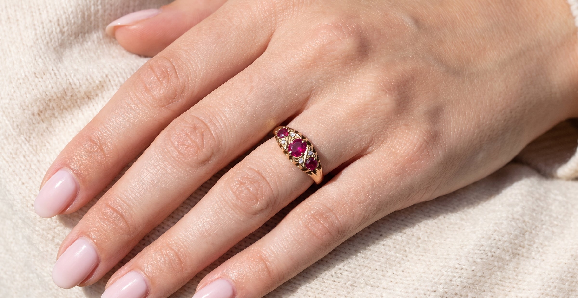 hand An 18 carat gold antique boat shaped ring. Features three lovely coloured wine red rubies, centre 5x4mm, each end 2.4mm.