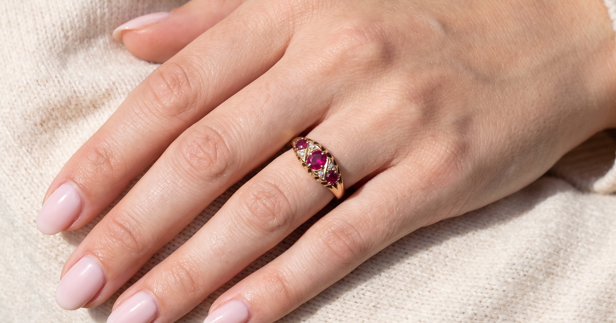 hand An 18 carat gold antique boat shaped ring. Features three lovely coloured wine red rubies, centre 5x4mm, each end 2.4mm.