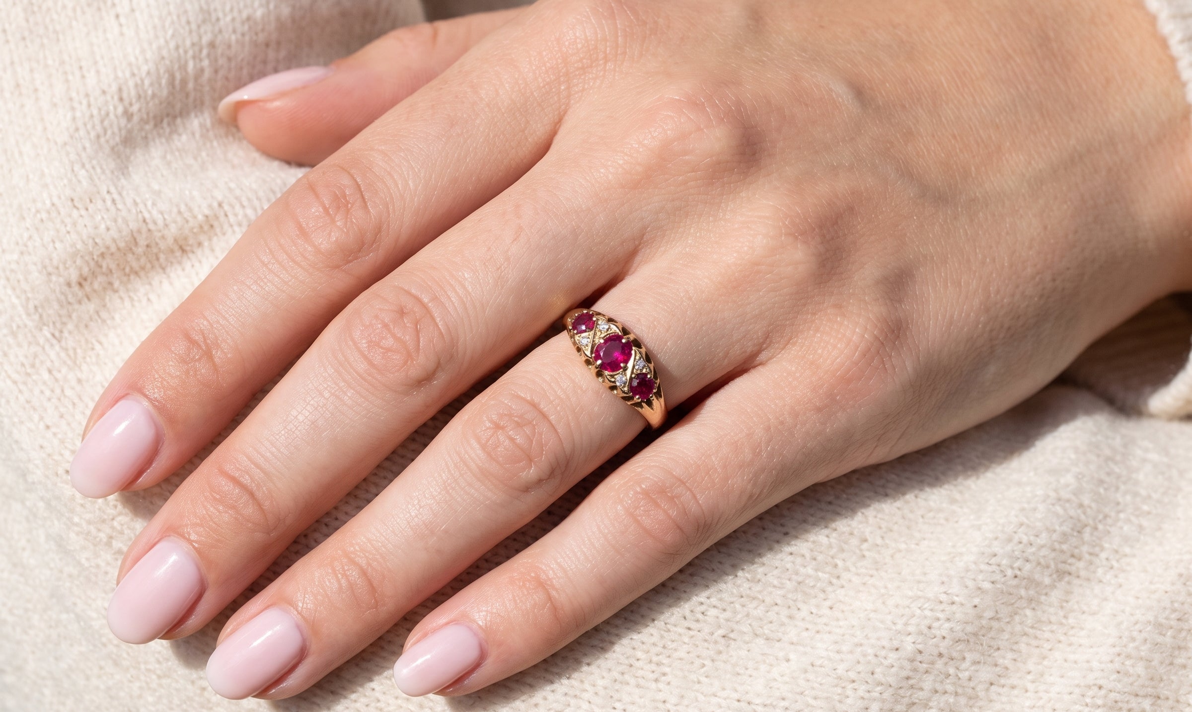 hand An 18 carat gold antique boat shaped ring. Features three lovely coloured wine red rubies, centre 5x4mm, each end 2.4mm.