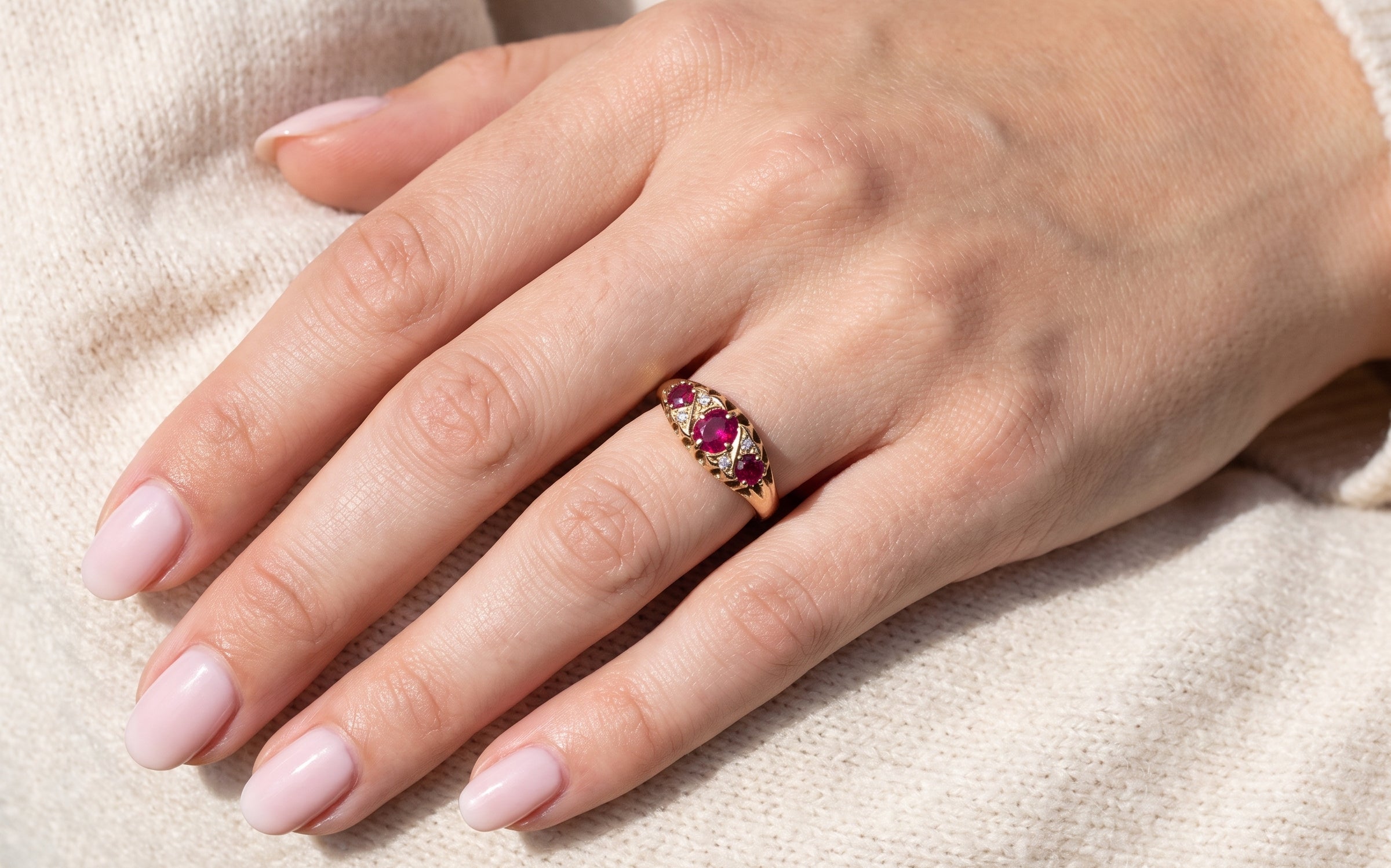hand An 18 carat gold antique boat shaped ring. Features three lovely coloured wine red rubies, centre 5x4mm, each end 2.4mm.