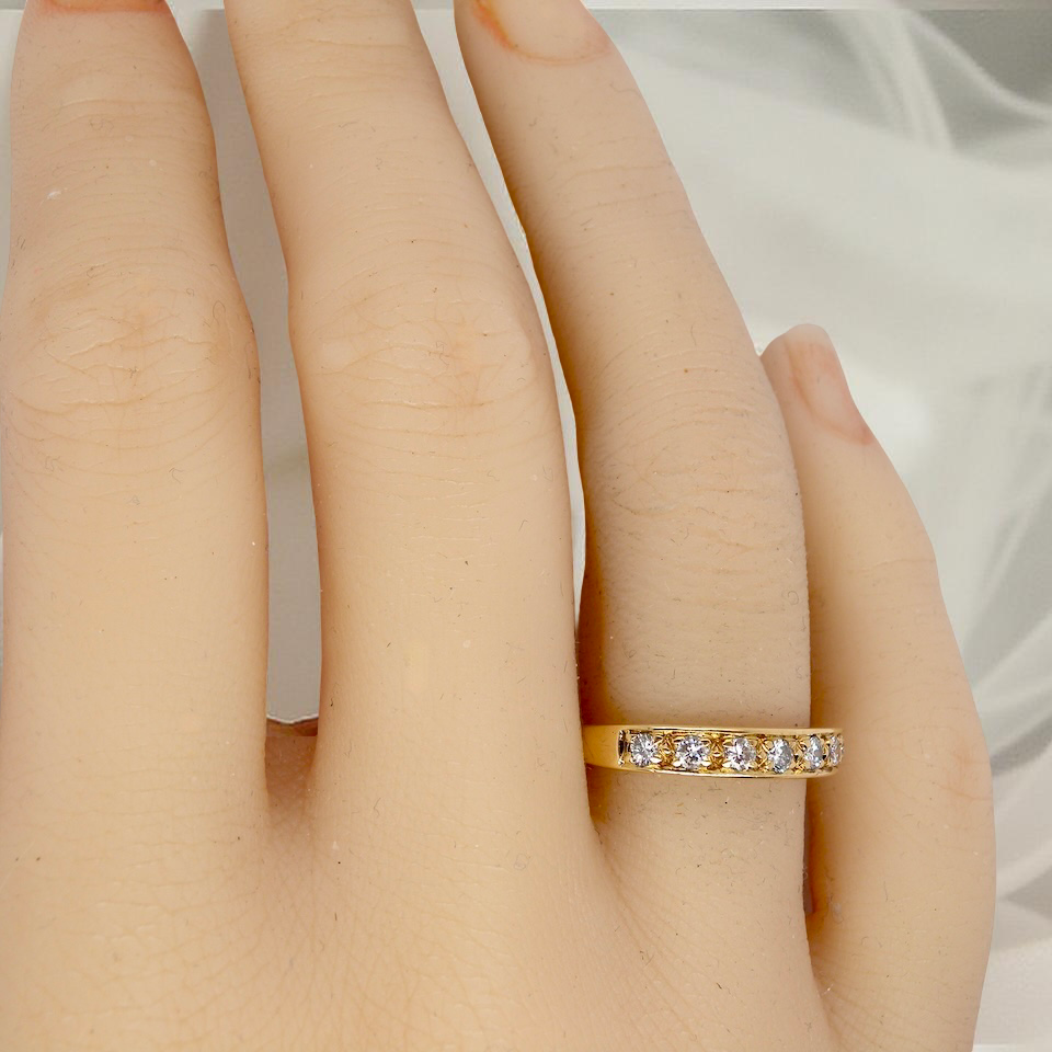 hand An 18 carat gold half-hoop eternity ring, set with eight brilliant-cut white diamonds