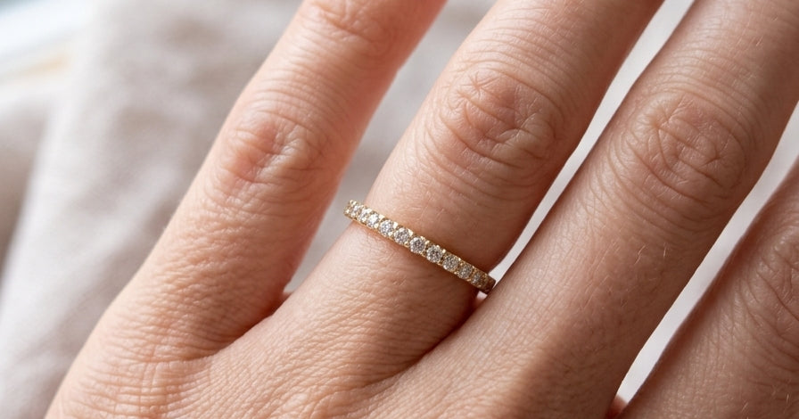 hand An 18 carat yellow gold half hoop diamond eternity ring originally purchased from Goldsmiths