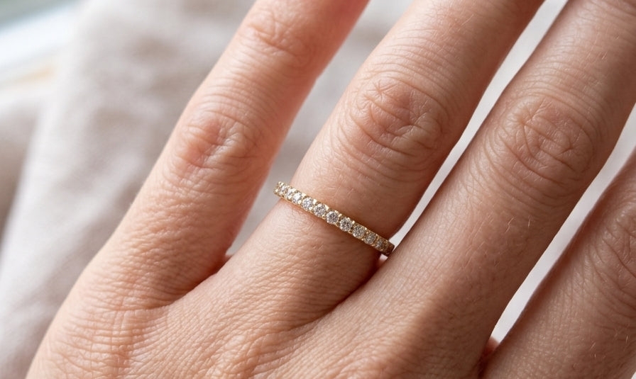 hand An 18 carat yellow gold half hoop diamond eternity ring originally purchased from Goldsmiths