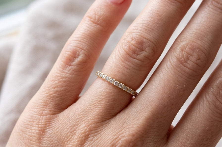 hand An 18 carat yellow gold half hoop diamond eternity ring originally purchased from Goldsmiths