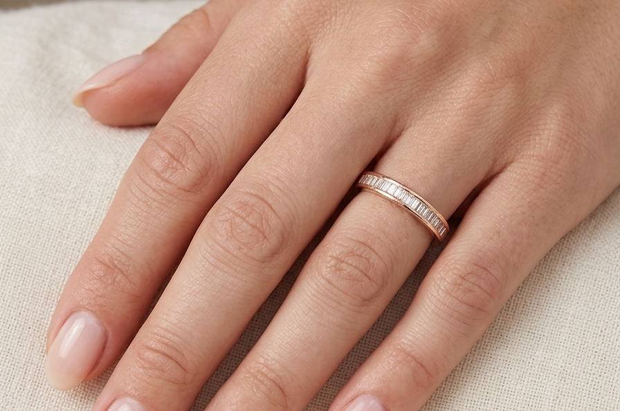 hand An 18 carat yellow gold half hoop eternity ring.
Set with thirty baguette cut white diamonds,