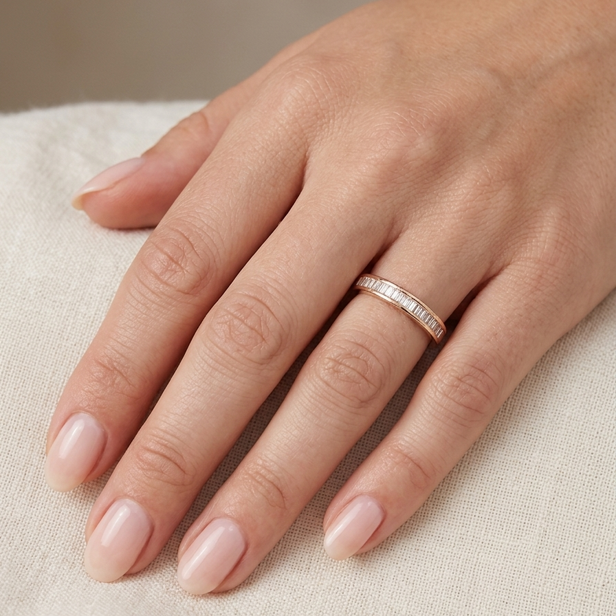 hand An 18 carat yellow gold half hoop eternity ring.
Set with thirty baguette cut white diamonds,