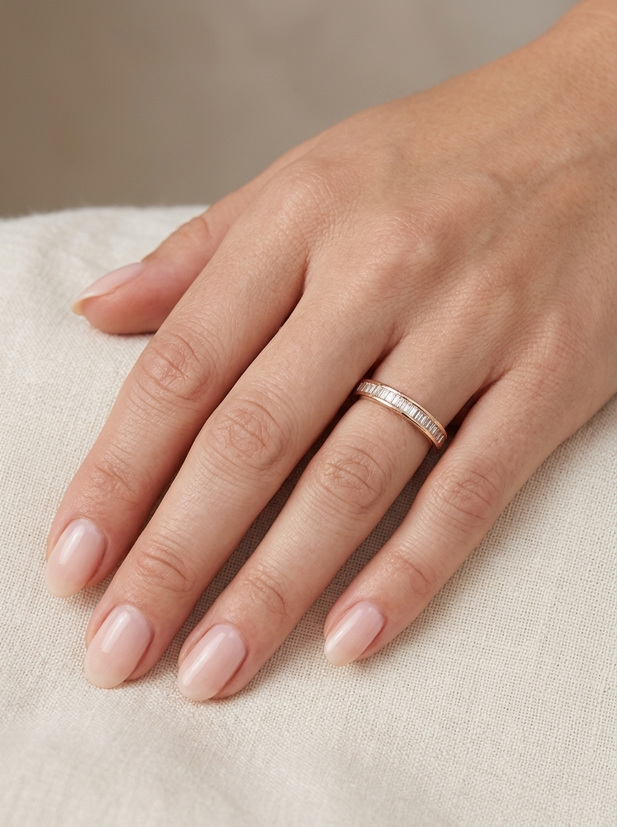 hand An 18 carat yellow gold half hoop eternity ring.
Set with thirty baguette cut white diamonds,