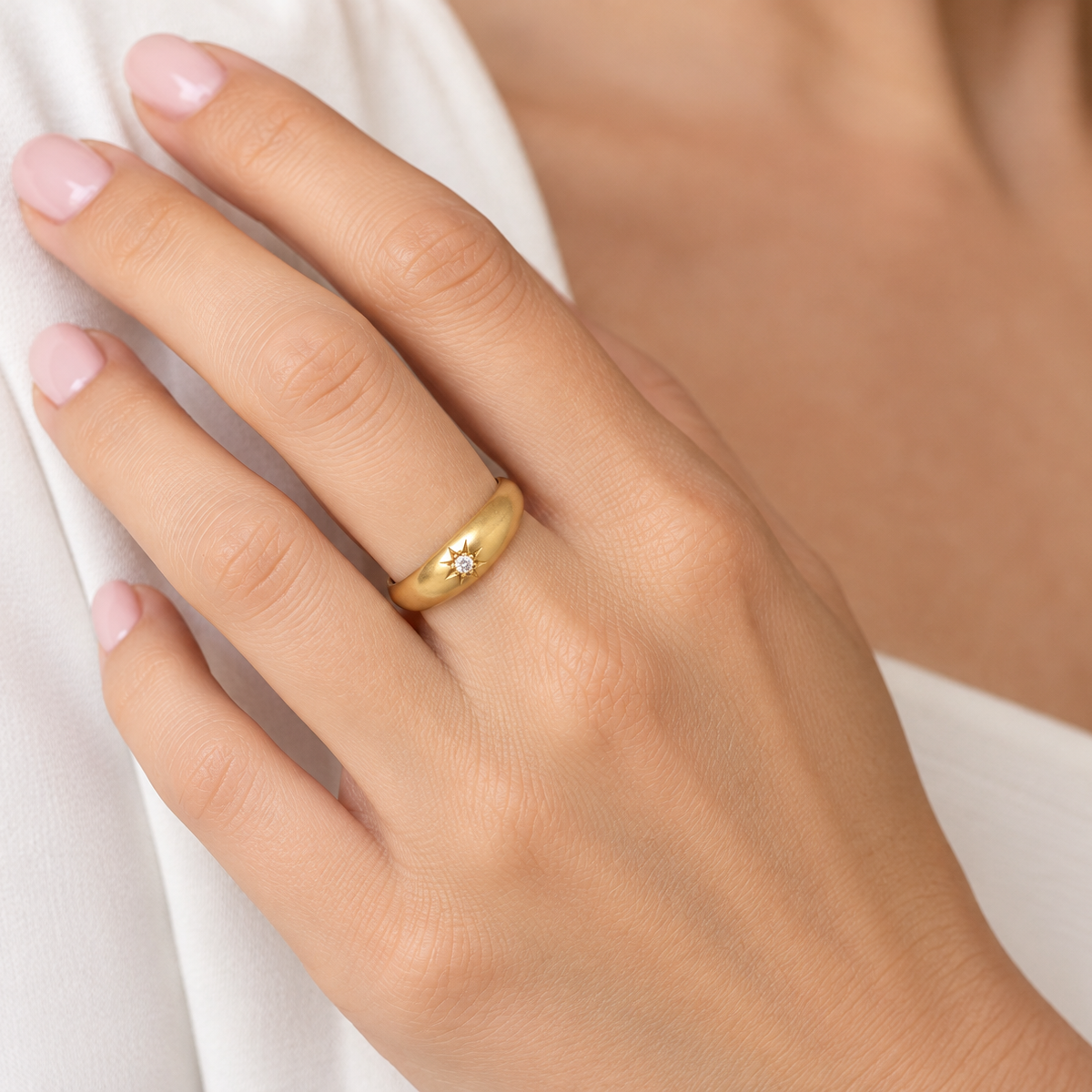 hand An 18 carat yellow gold ring, sometimes referred to as a 'gypsy' ring. The diamond measures 2.4mm (0.05 carats) star set.