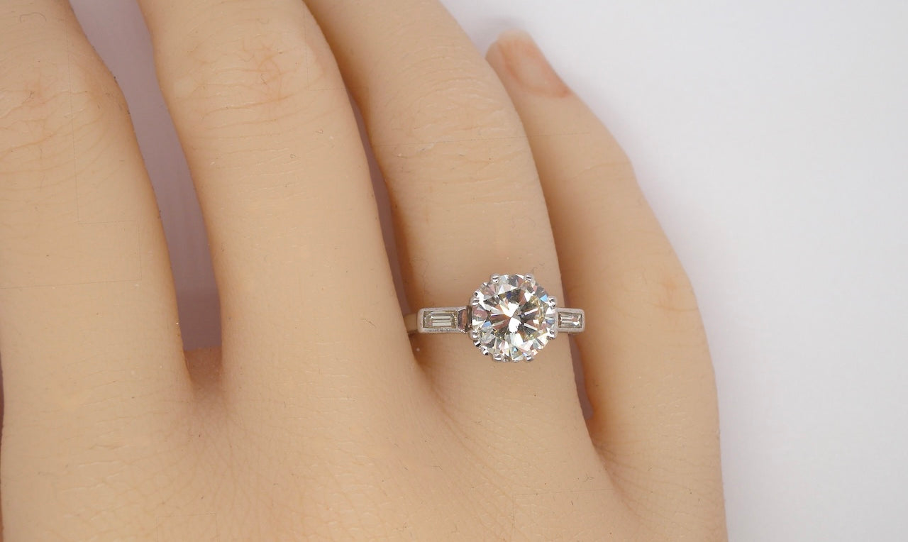 hand An Art Deco solitaire ring showcasing a beautiful 1.75 carat diamond
