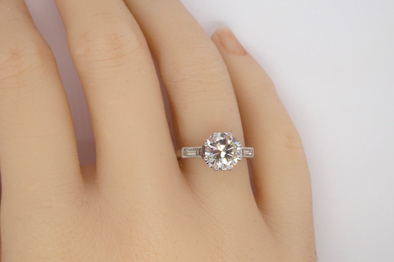 hand An Art Deco solitaire ring showcasing a beautiful 1.75 carat diamond