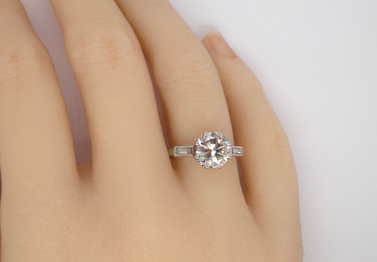 hand An Art Deco solitaire ring showcasing a beautiful 1.75 carat diamond