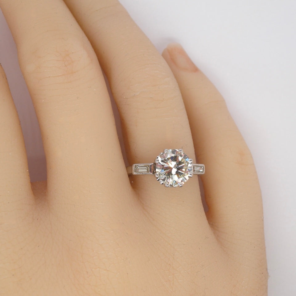 hand An Art Deco solitaire ring showcasing a beautiful 1.75 carat diamond