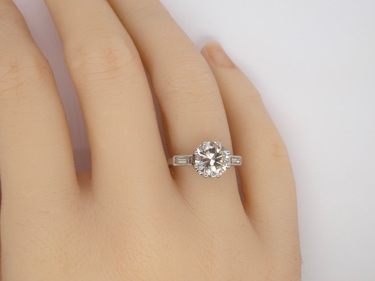 hand An Art Deco solitaire ring showcasing a beautiful 1.75 carat diamond
