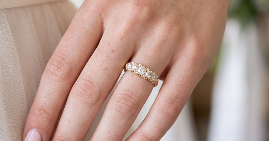 hand An antique boat shaped five stone ring. Set with five old cut white diamonds. Centre 5mm (0.45-0.50 carats) each side a 4mm stone, at each end a 2.4mm stone. Total diamond content estimated at one carat.