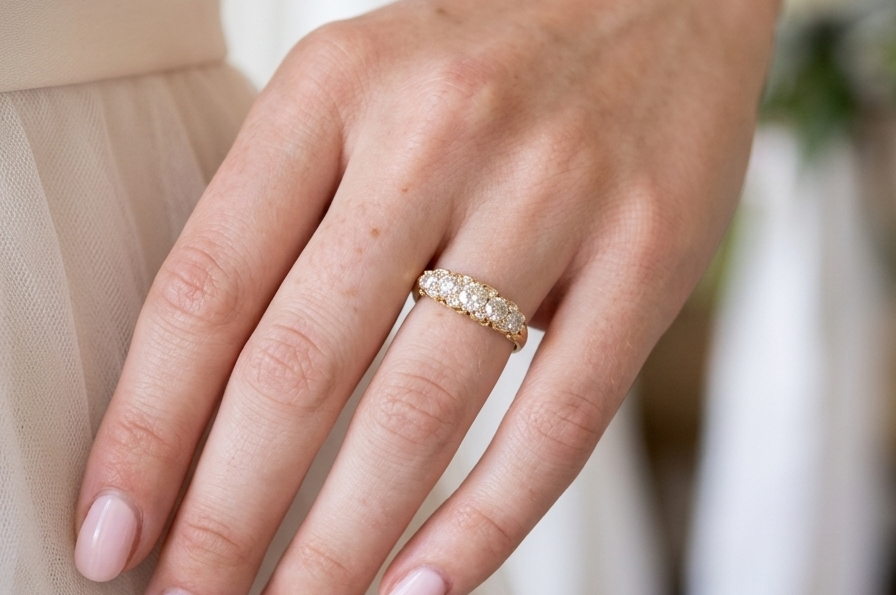 hand An antique boat shaped five stone ring. Set with five old cut white diamonds. Centre 5mm (0.45-0.50 carats) each side a 4mm stone, at each end a 2.4mm stone. Total diamond content estimated at one carat.