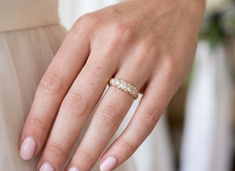 hand An antique boat shaped five stone ring. Set with five old cut white diamonds. Centre 5mm (0.45-0.50 carats) each side a 4mm stone, at each end a 2.4mm stone. Total diamond content estimated at one carat.