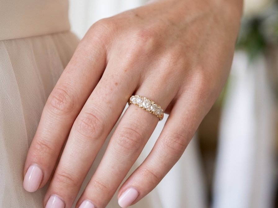 hand An antique boat shaped five stone ring. Set with five old cut white diamonds. Centre 5mm (0.45-0.50 carats) each side a 4mm stone, at each end a 2.4mm stone. Total diamond content estimated at one carat.