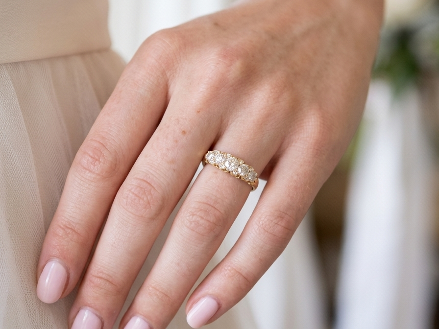 hand An antique boat shaped five stone ring. Set with five old cut white diamonds. Centre 5mm (0.45-0.50 carats) each side a 4mm stone, at each end a 2.4mm stone. Total diamond content estimated at one carat.
