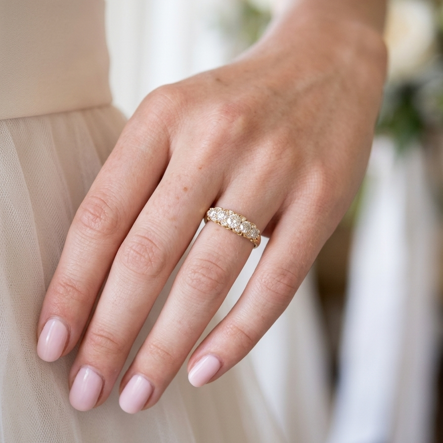 hand An antique boat shaped five stone ring. Set with five old cut white diamonds. Centre 5mm (0.45-0.50 carats) each side a 4mm stone, at each end a 2.4mm stone. Total diamond content estimated at one carat.