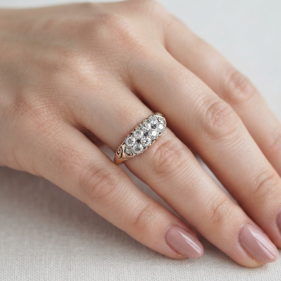 hand An eight stone boat shaped diamond ring, with two extra 'accent' diamonds to each end