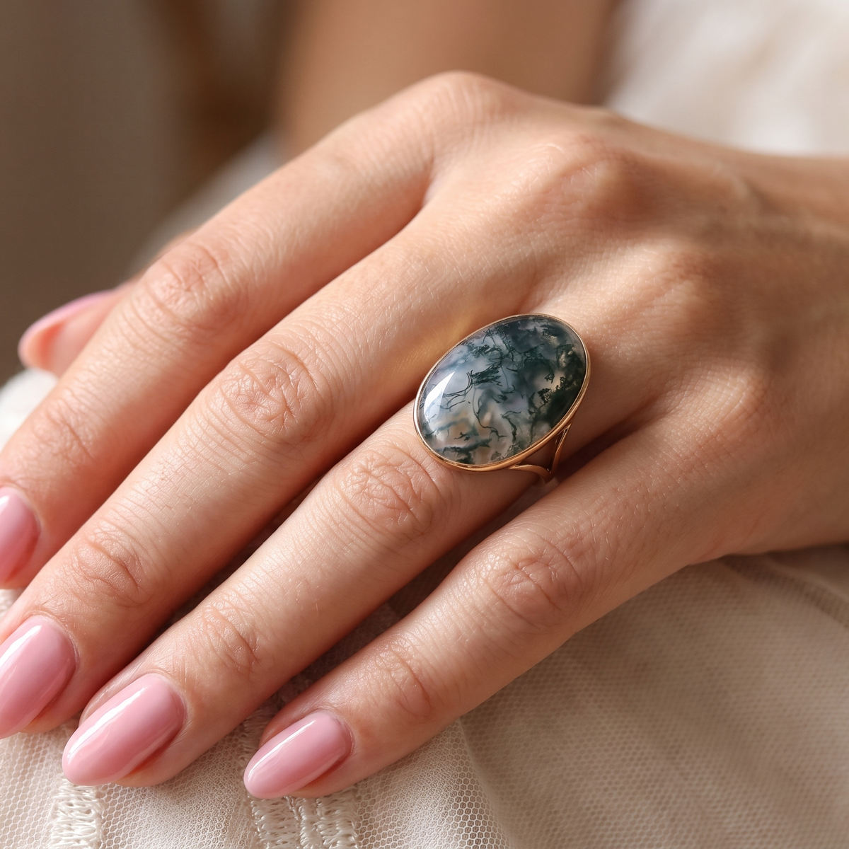 hand An impressive dress ring set with a large moss agate semi precious gem stone.