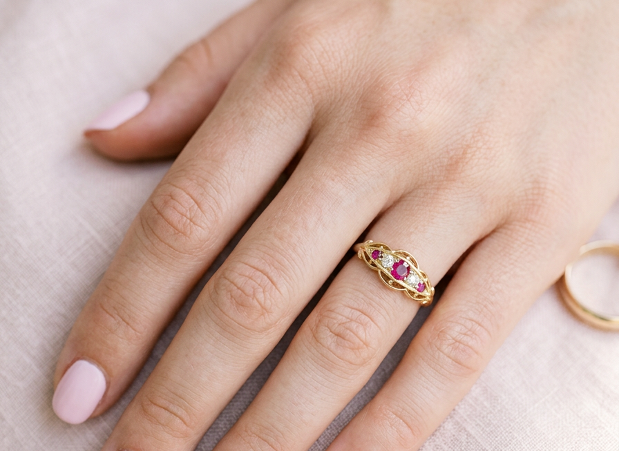 hand Set with three bright rubies, centre 3x2.6mm, each end a 2mm ruby. Each side of the centre stone an old brilliant cut white diamond 2.8mm (est 0.08 carats) . Head measures 17x7mm, weight 3.4grams. 