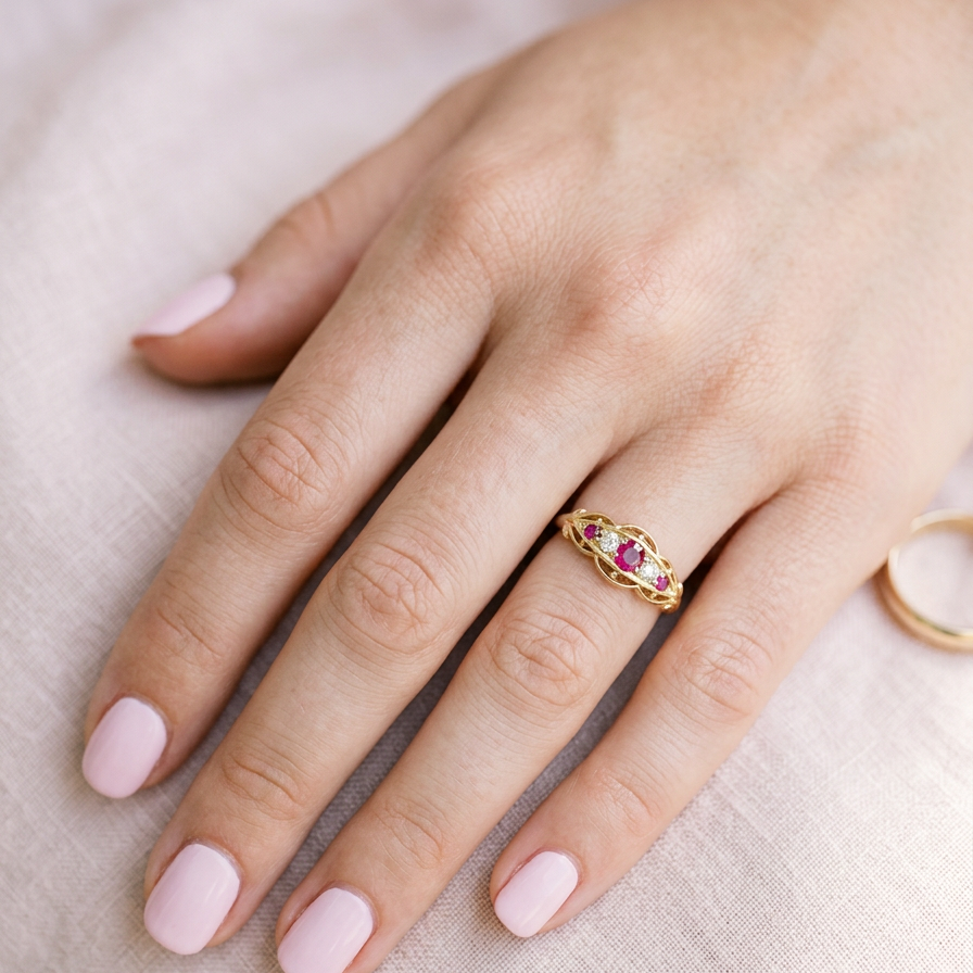 hand Set with three bright rubies, centre 3x2.6mm, each end a 2mm ruby. Each side of the centre stone an old brilliant cut white diamond 2.8mm (est 0.08 carats) . Head measures 17x7mm, weight 3.4grams. 