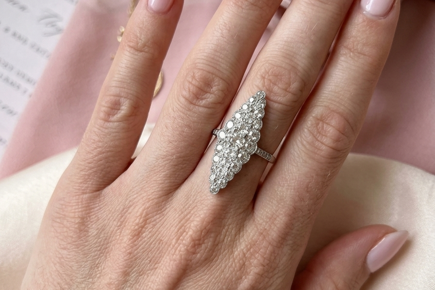 hand This is a striking marquise-shaped diamond cluster ring with a very classic, vintage-inspired look.
