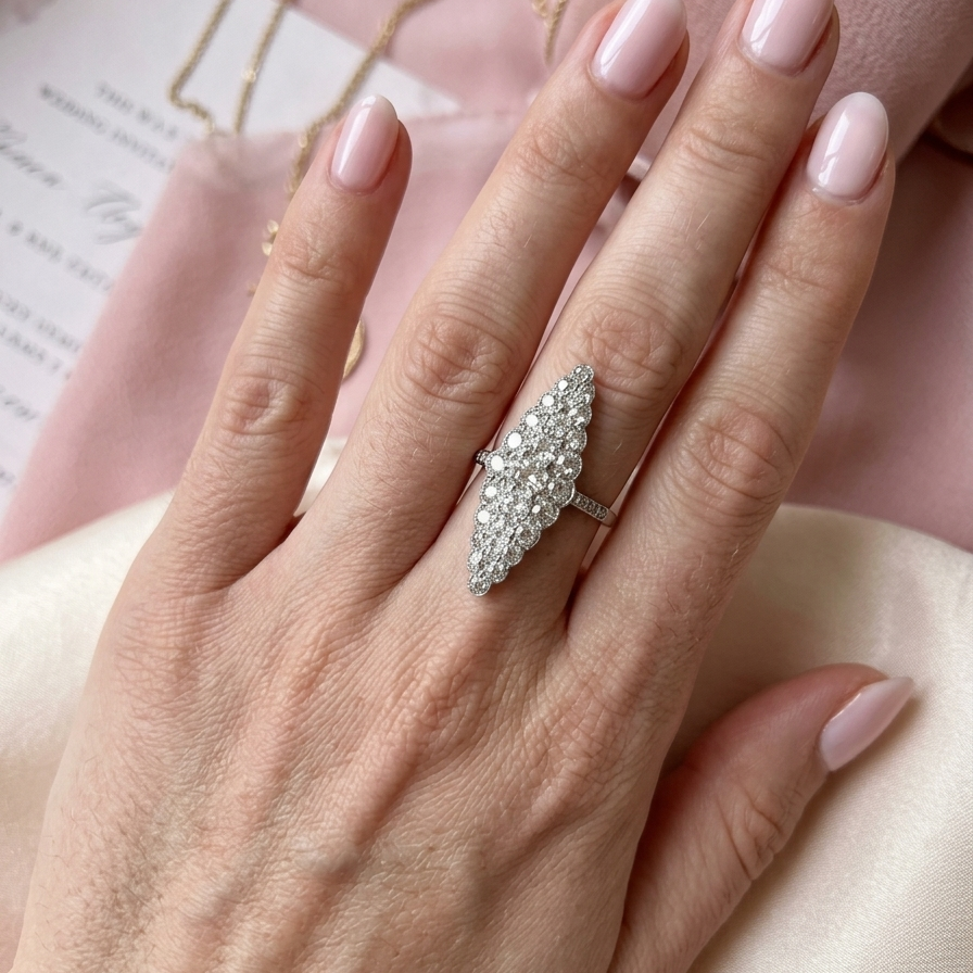 hand This is a striking marquise-shaped diamond cluster ring with a very classic, vintage-inspired look.