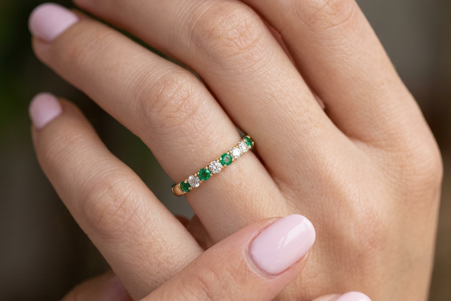 hand This ring is set with six bright green emeralds, each 2mm, (est 0.25 carats) and five 2mm brilliant cut white diamonds.