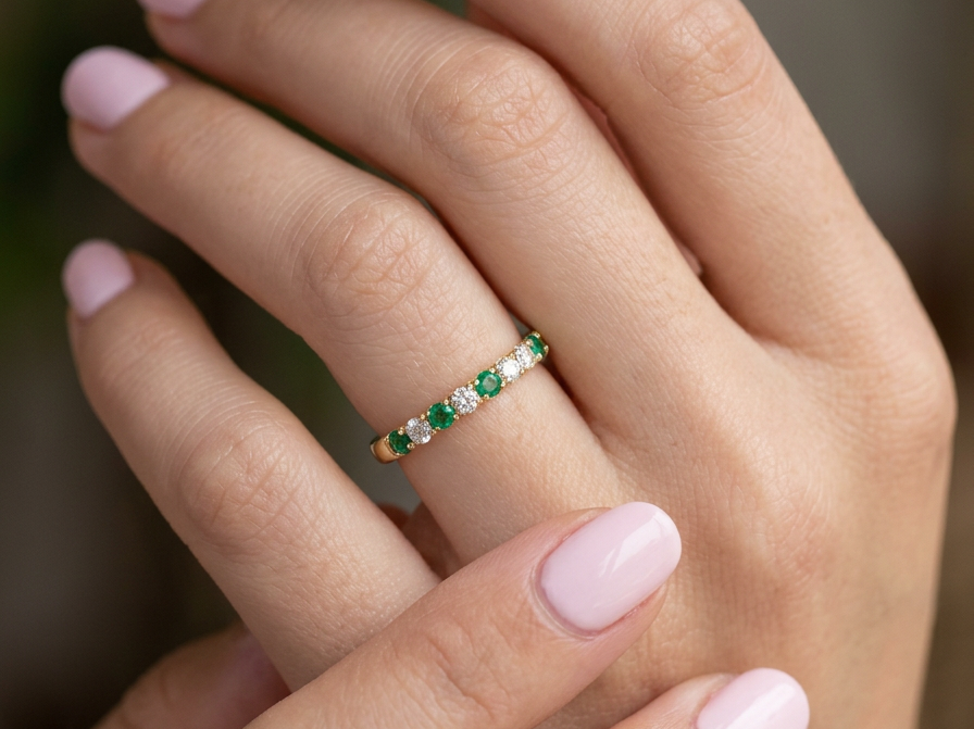 hand This ring is set with six bright green emeralds, each 2mm, (est 0.25 carats) and five 2mm brilliant cut white diamonds.