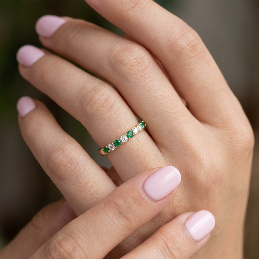 hand This ring is set with six bright green emeralds, each 2mm, (est 0.25 carats) and five 2mm brilliant cut white diamonds.