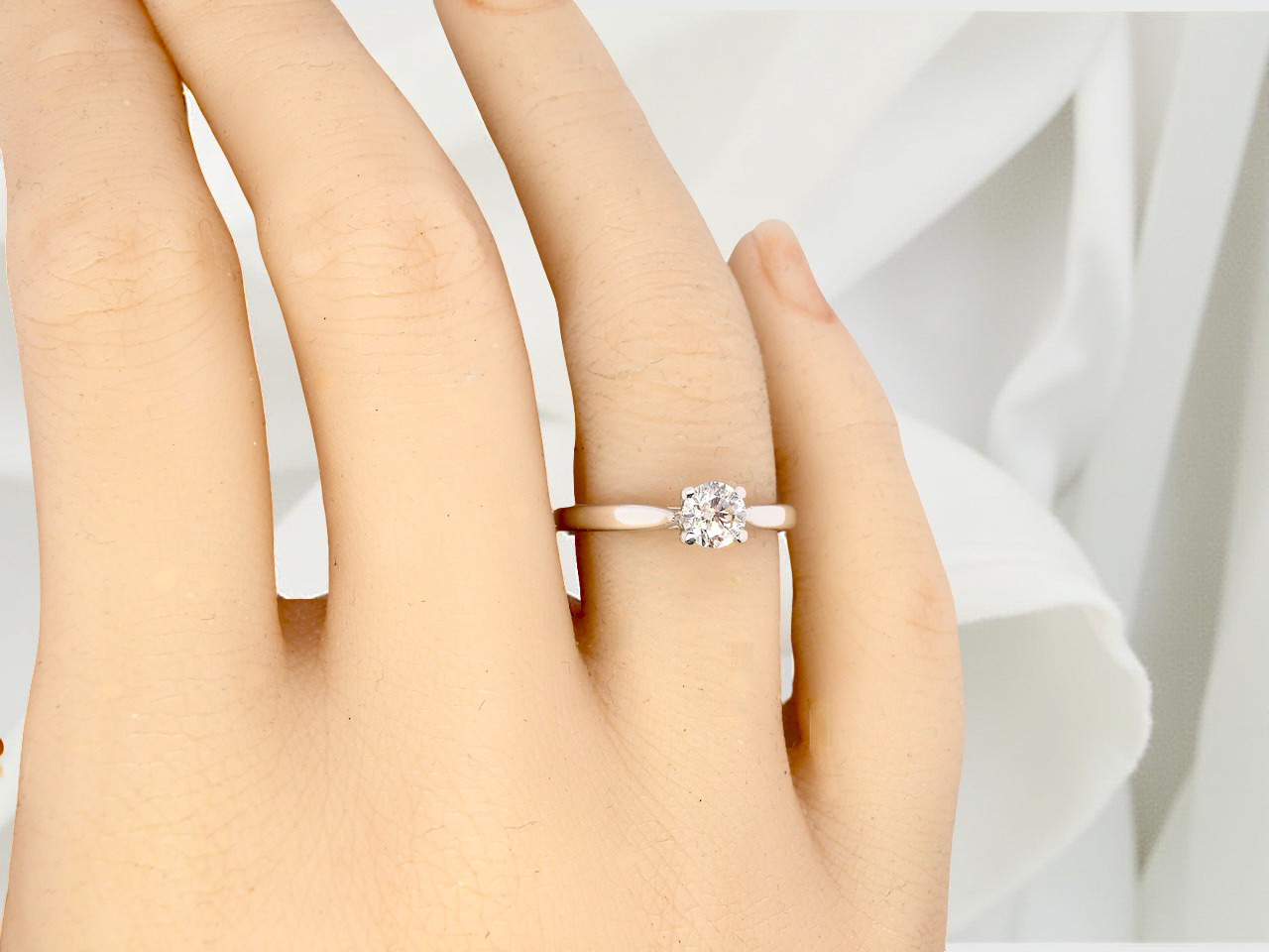 hand beautifully crafted solitaire ring featuring a brilliant-cut white diamond