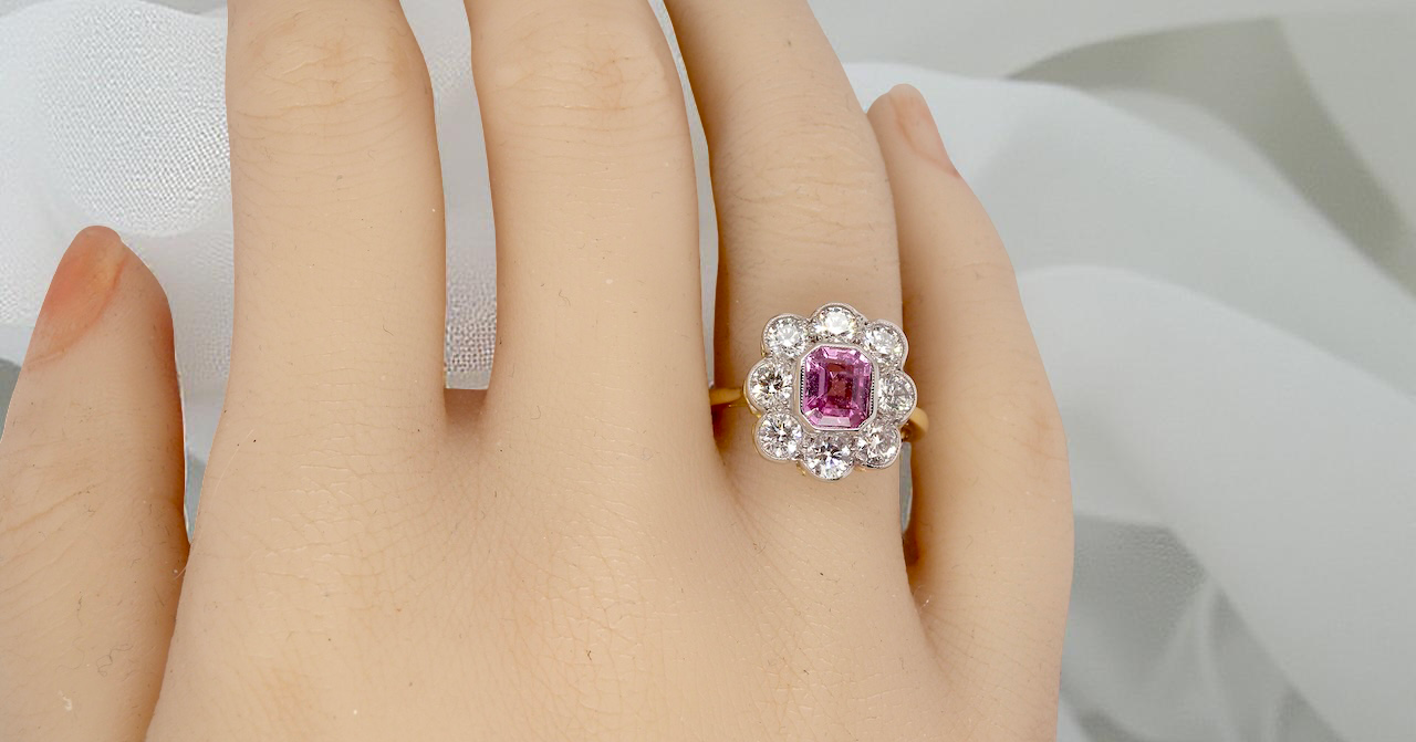 hand cluster ring featuring a beautiful cushion-cut pink sapphire