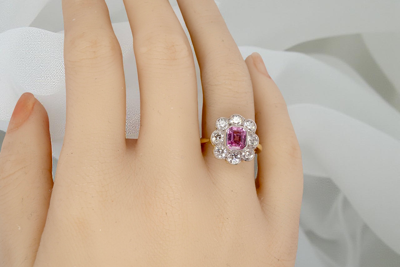 hand cluster ring featuring a beautiful cushion-cut pink sapphire