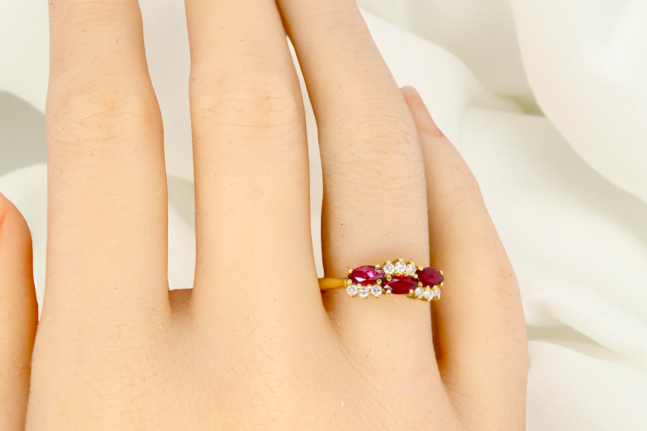 hand diamond ring with marquise-cut rubies (5×3 mm each).