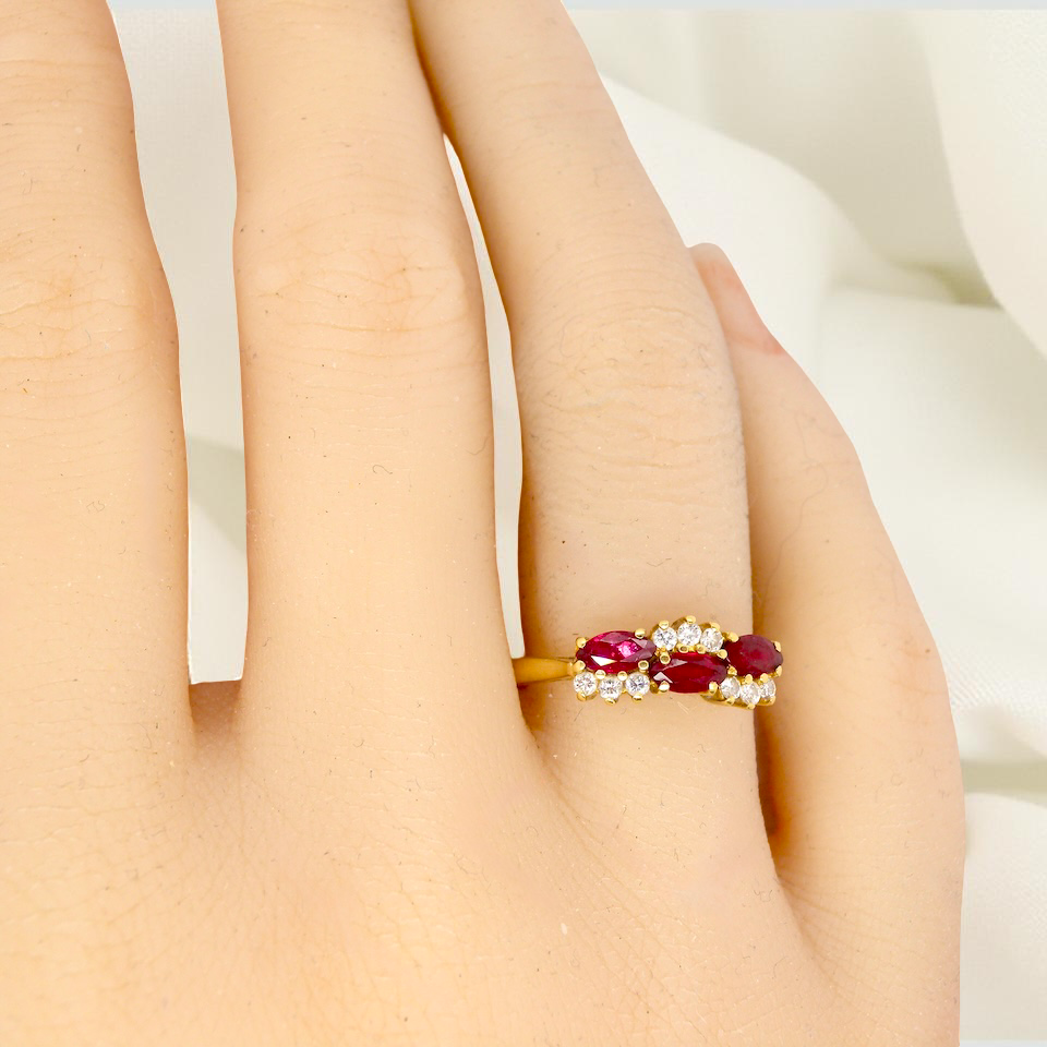 hand diamond ring with marquise-cut rubies (5×3 mm each).