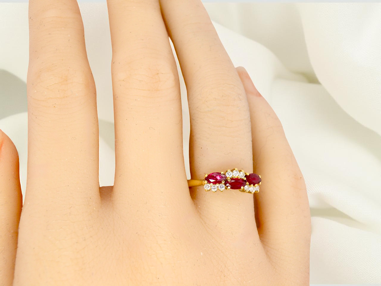 hand diamond ring with marquise-cut rubies (5×3 mm each).
