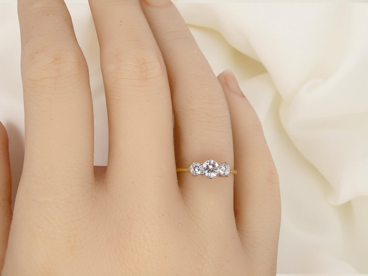 hand elegant modern trilogy ring is set with three brilliant-cut white diamonds in a timeless and meaningful design.