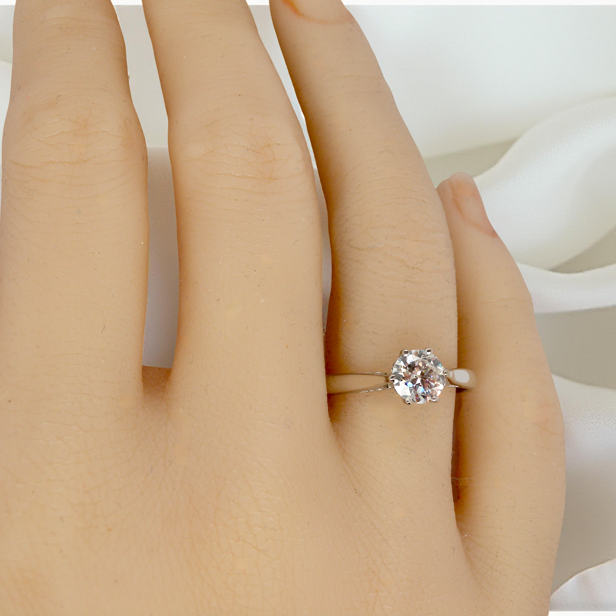 hand fine solitaire ring featuring a single brilliant-cut white diamond, measuring approximately 6mm (estimated 0.75 carats).