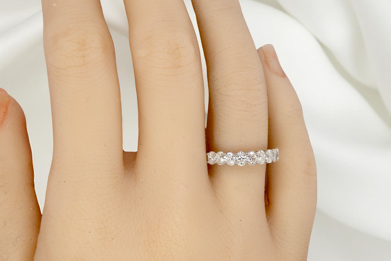 hand gorgeous half-hoop eternity ring set with nine oval brilliant-cut white diamonds.